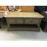 An oak coffee table with side drawers and under tier