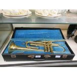 A three valve brass trumpet with hard case by Melody Maker (A/F)