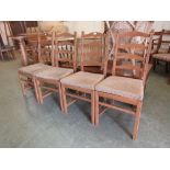 A set of four light Ercol modern dining chairs with rail backs