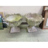 A pair of composite stone garden planters on stands