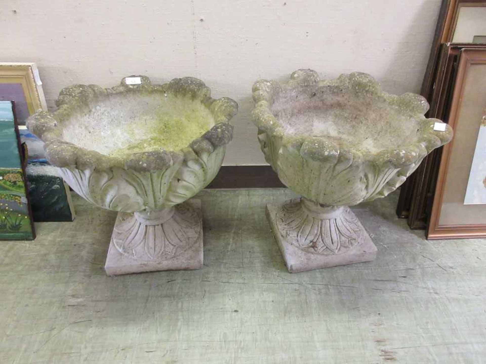 A pair of composite stone garden planters on stands