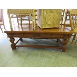 A cherrywood coffee table with side drawers