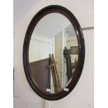 An early 20th century oval bevel glass mirror