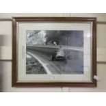 A framed and glazed photographic print of Fangio in the French Grand Prix in 1957