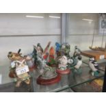 A collection of bird figurines to include kingfisher, owl, robin, etc