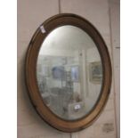 An early 20th century gilt framed oval mirror