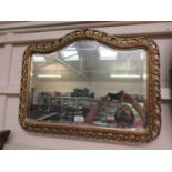 An ornate gilt framed bevel glass mirror