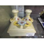 A Moorcroft yellow glazed trinket box along with a pair of matching candlesticks