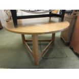A circular pine kitchen table on hexagonal legs