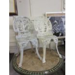 A pair of cast aluminium white painted garden chairs