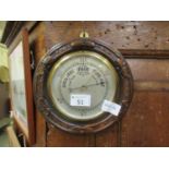 An early 20th century circular oak barometer
