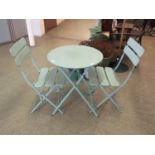 A turquoise metal folding bistro set