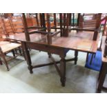 An early 20th century oak extending dining table