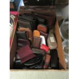 A tray containing leatherware to include wallets, purses, satchel, etc