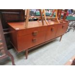 A mid-20th century teak sideboard, three drawers alongside two cupboard doors