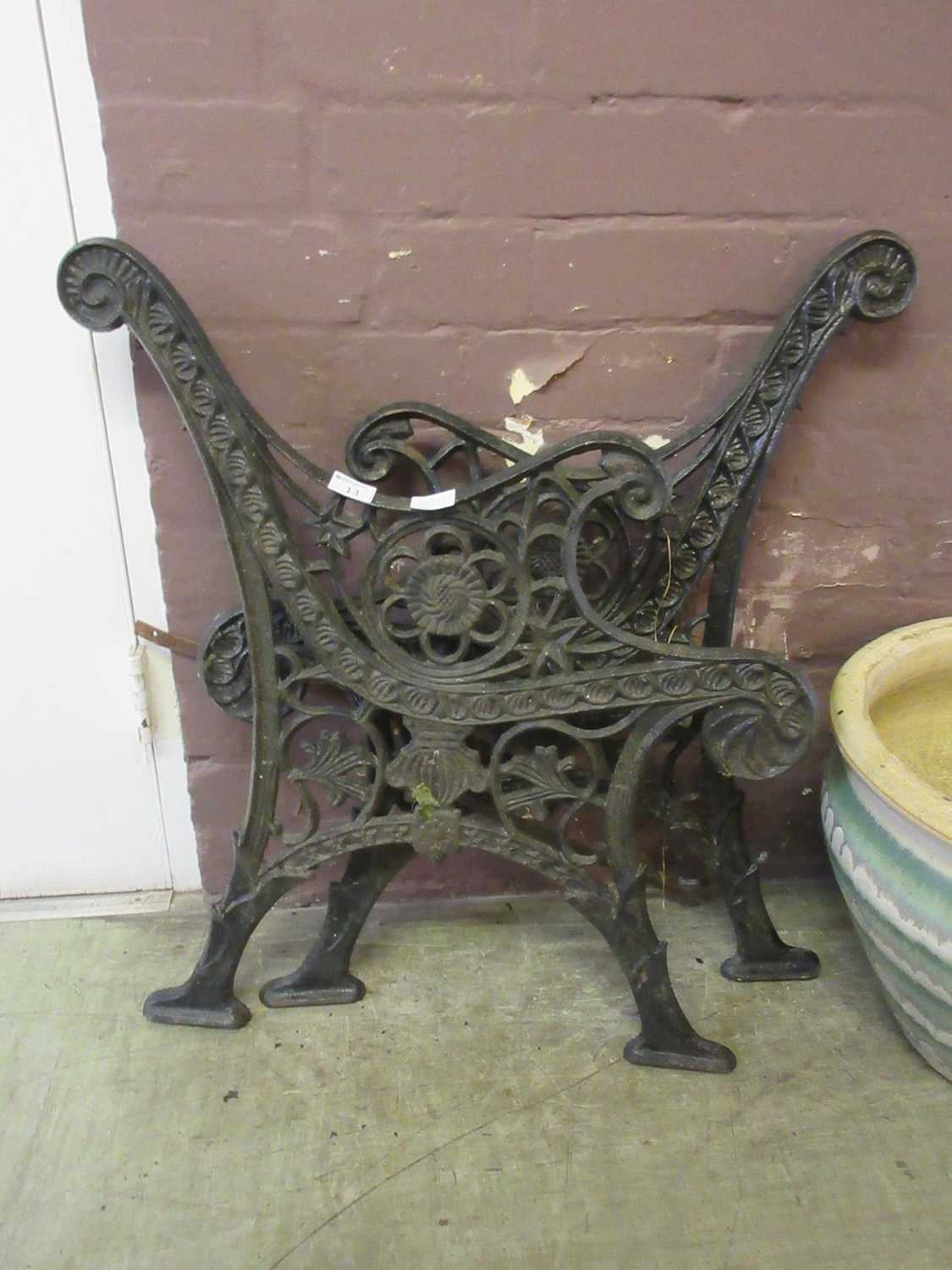 A pair of black painted cast iron bench ends