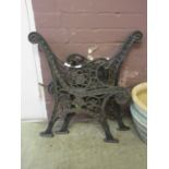 A pair of black painted cast iron bench ends