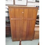 An early 20th century oak two door wardrobe