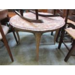 A pink marble topped table on carved cabriole legs