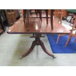 A 19th century mahogany breakfast table, the rectangular top on turned column and three splay legs