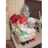Three plastic moulded models of gnomes