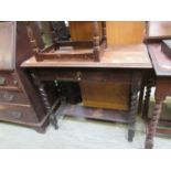 An early 20th century oak single drawer side table with under tier