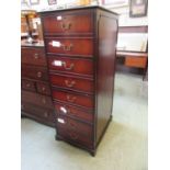 A modern mahogany filing cabinet having four filing drawers