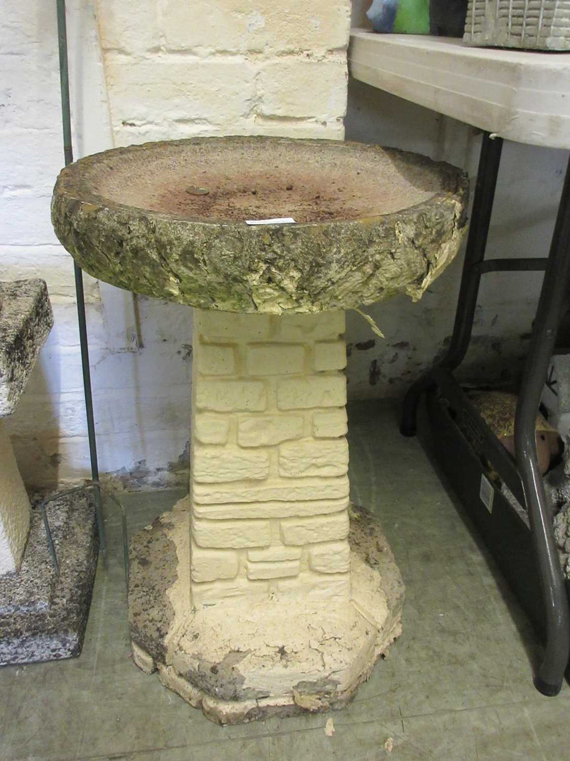 A composite stone birdbath