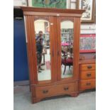 An early 20th century walnut two bevelled mirror door wardrobe with drawer to base (A/F)