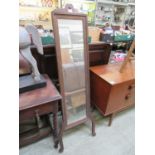 An early 20th century oak framed cheval mirror