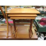 A nest of three mid-20th century teak tables