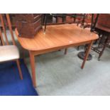 A modern teak extending dining table