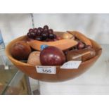 A bowl containing wooden fruit