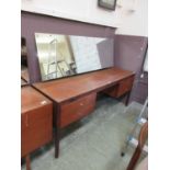 A mid-20th century teak dressing table, the sloping mirror on the base with a pair of two drawers