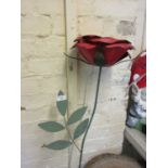 A large garden metalwork poppy