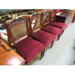 A set of four Edwardian walnut dining chairs upholstered in a patterned red fabric