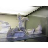 Three Highbank porcelain figural groups of dolphins and seals