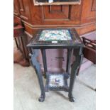 A late 19th century ebonised two tier stand with bird design tiled top and under tier