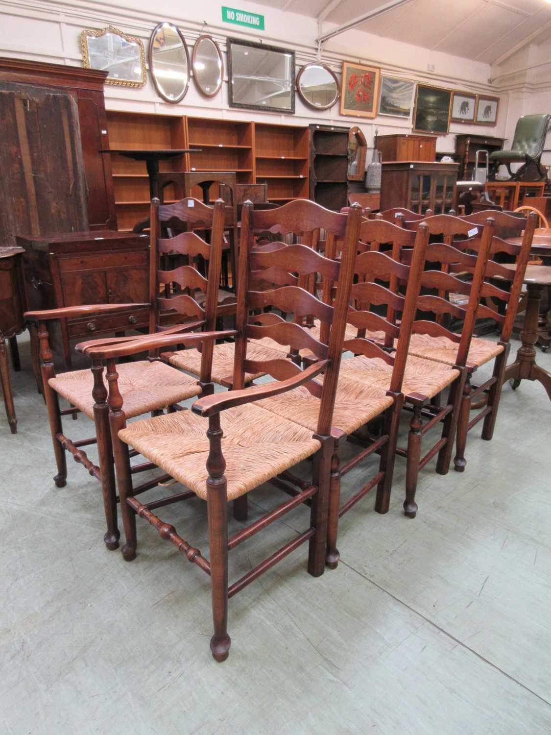 A set of eight (Six plus two) reproduction ash ladder back chairs with sea grass seats