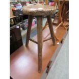 A primitive elm and ash three legged stool