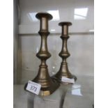 A pair of brass push candlesticks