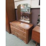 An early 20th century oak dressing chest, the bevelled plate over three drawers