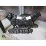 A pair of cast metal doorstops in the form of rams