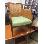An early 20th century walnut framed armchair with caned back and sides