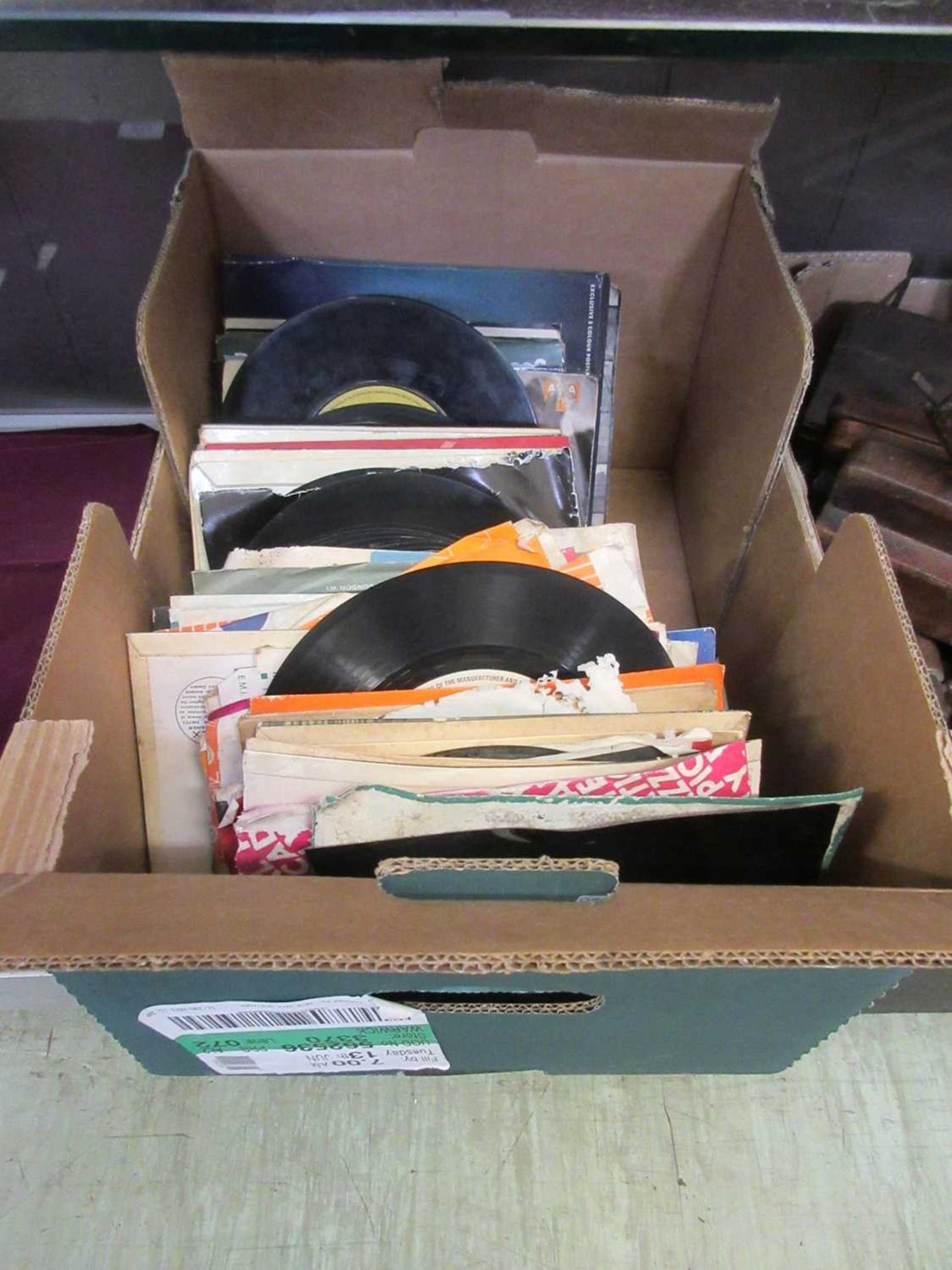 A box containing a collection of 45 rpm records to include Cliff Richard