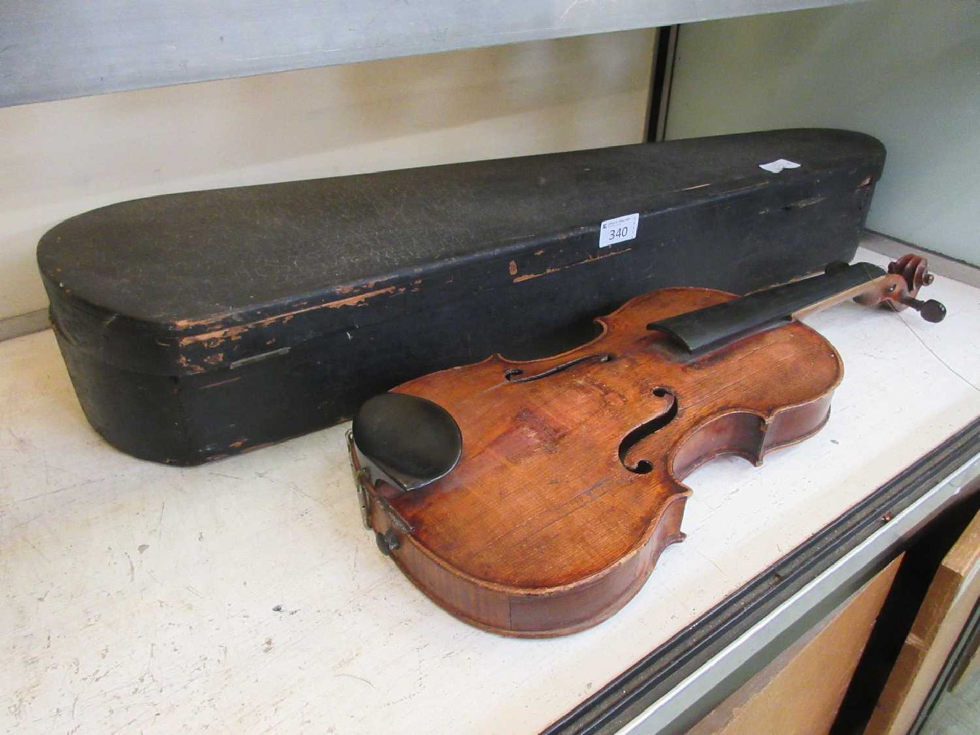 A 19th century violin with paper labelLength of body (Excluding base of neck) 35.5cm.