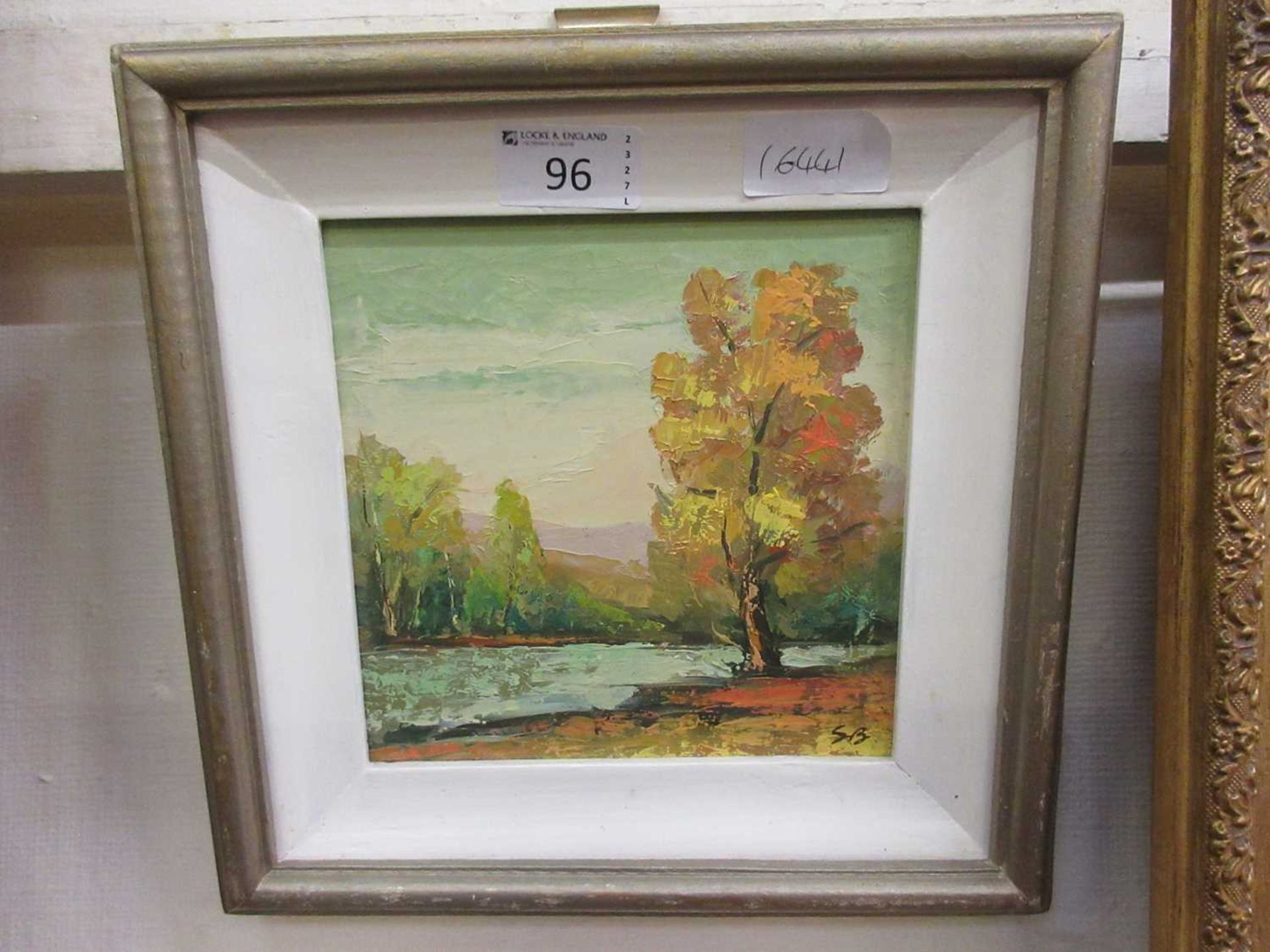 A framed oil on canvas of woodland lake scene initialled S.B