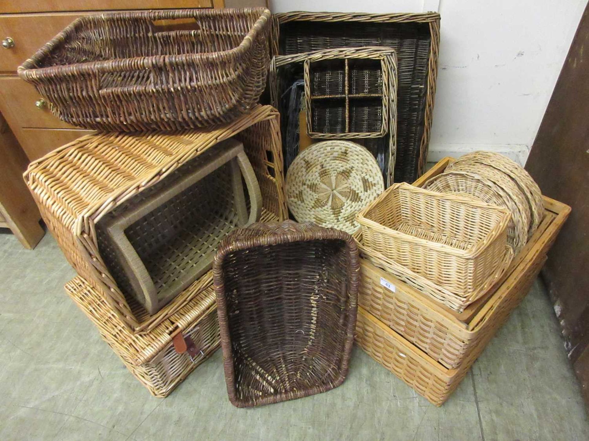 A large quantity of wicker baskets to include picnic hamper, bottle holder, etc