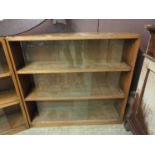 A mid-20th century oak bookcase with glass sliding doors