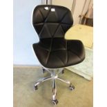 A black and cream leatherette upholstered office chair on five star base